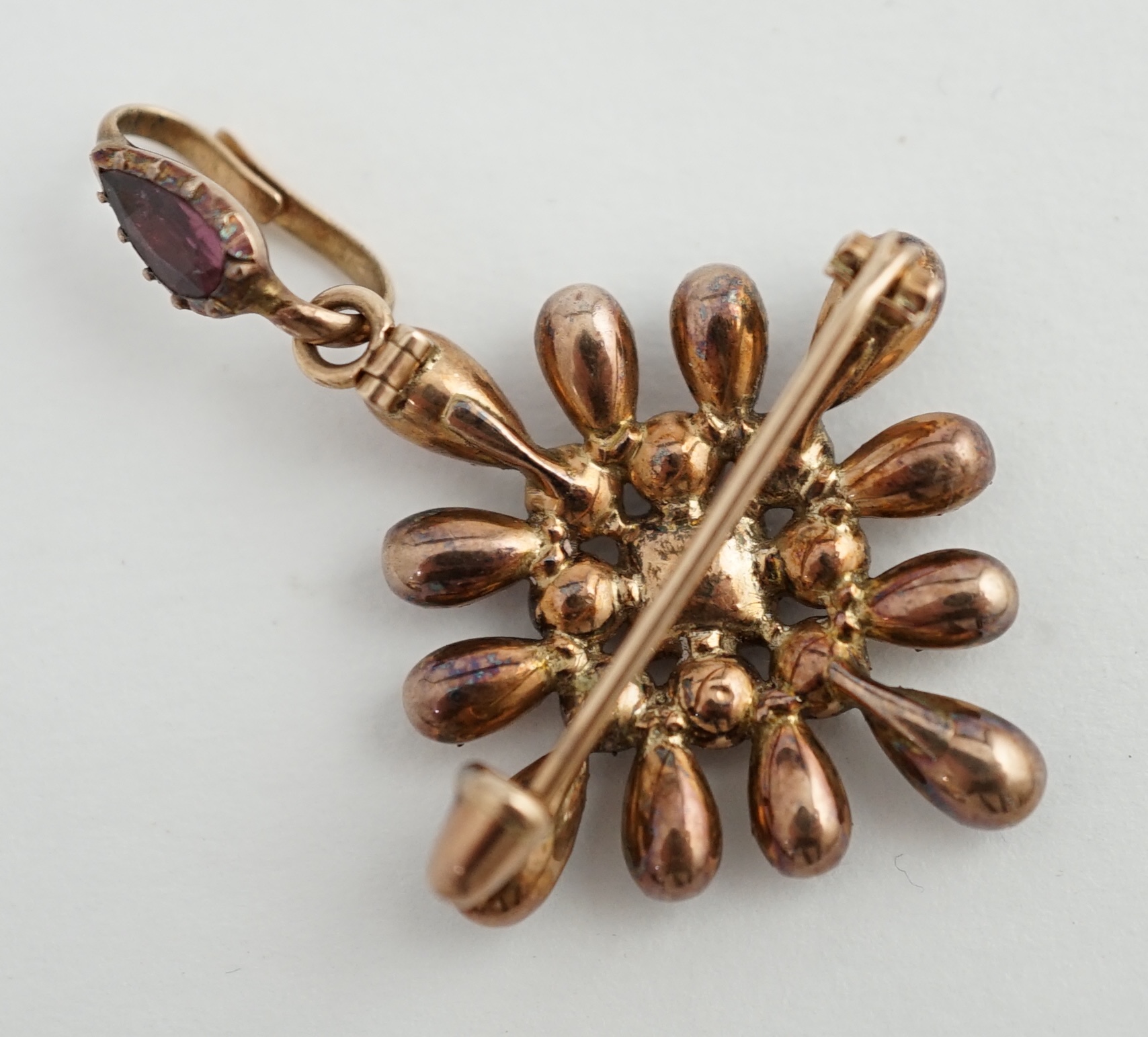 An early Victorian gold and garnet cluster set drop pendant brooch